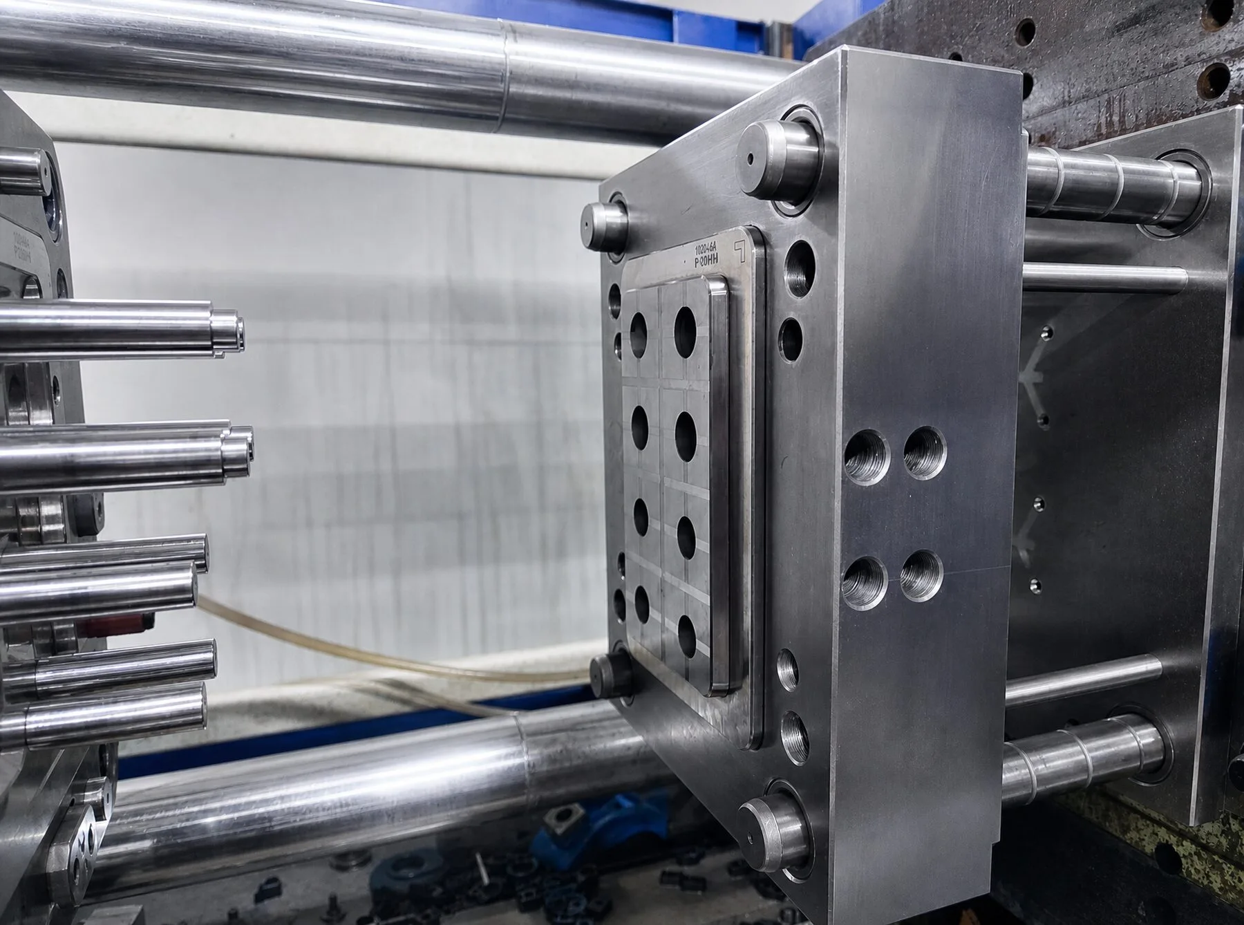 Open injection mold showing core pins and cooling
